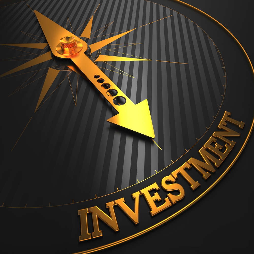 Investment - Business Background. Golden Compass Needle on a Black Field Pointing to the Word Investment. 3D Render.