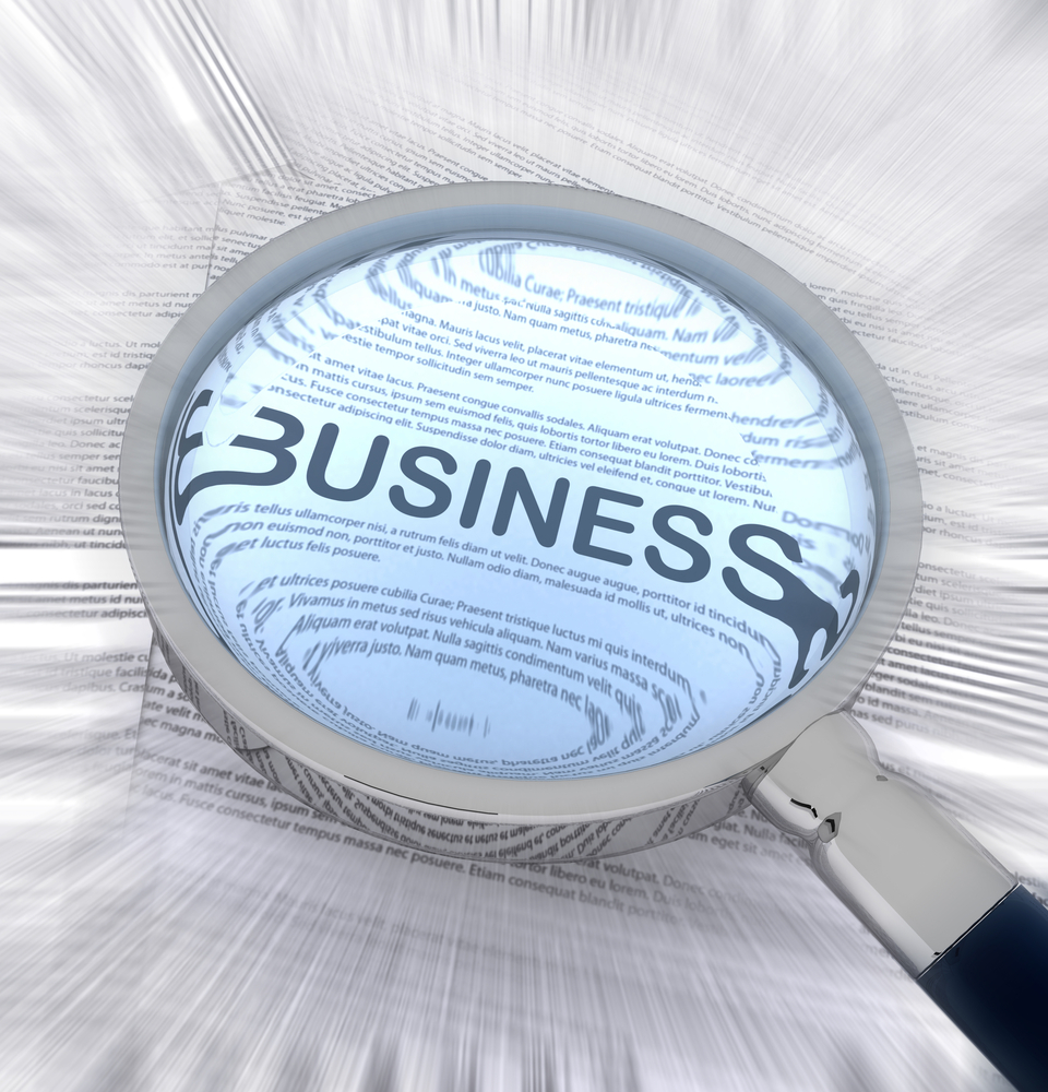 Word business written on paper and seen through a magnifying glass Word business written on paper and seen through a magnifying glass